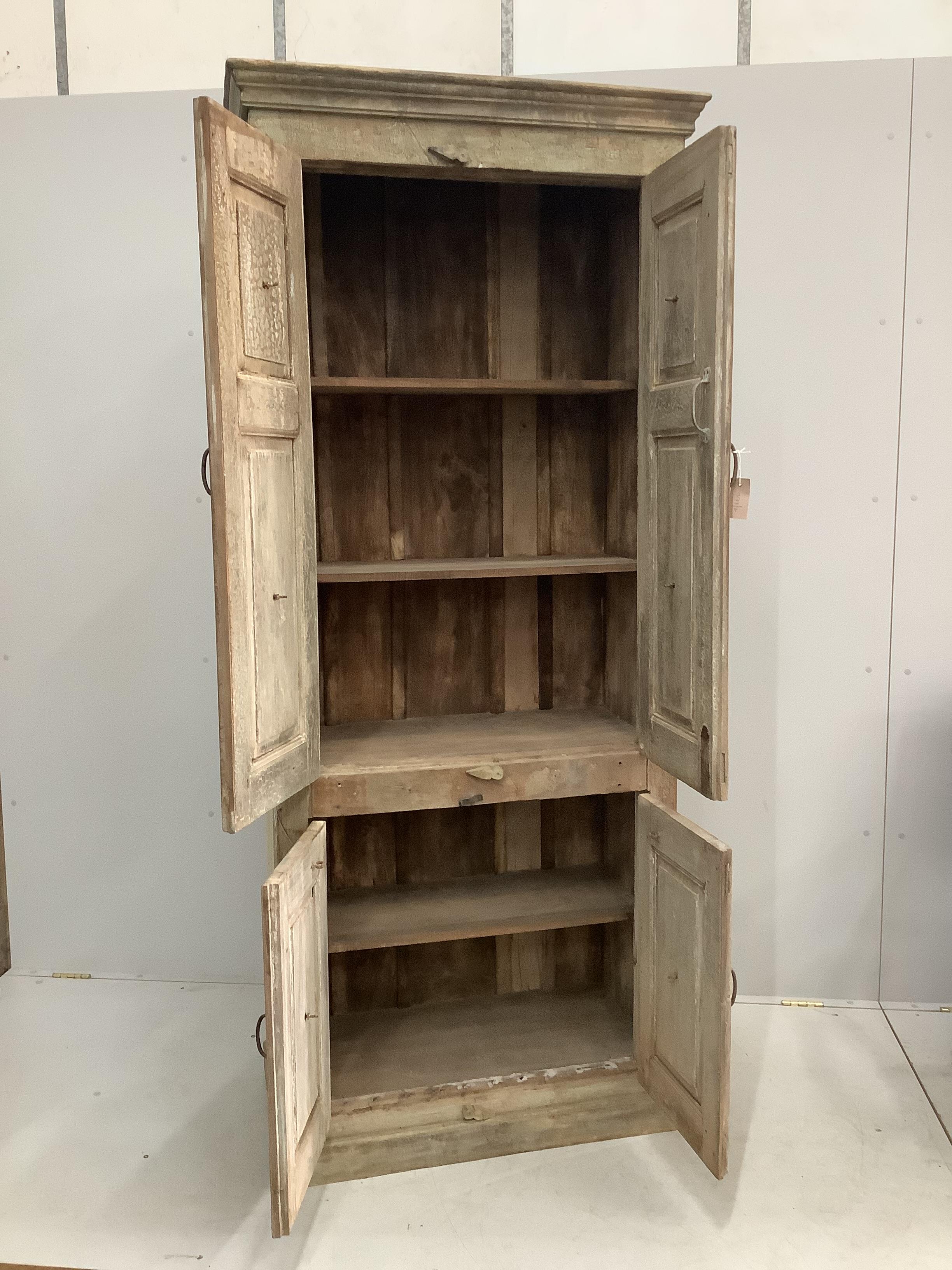 An Indian hardwood four door side cabinet, width 89cm, depth 48cm, height 210cm